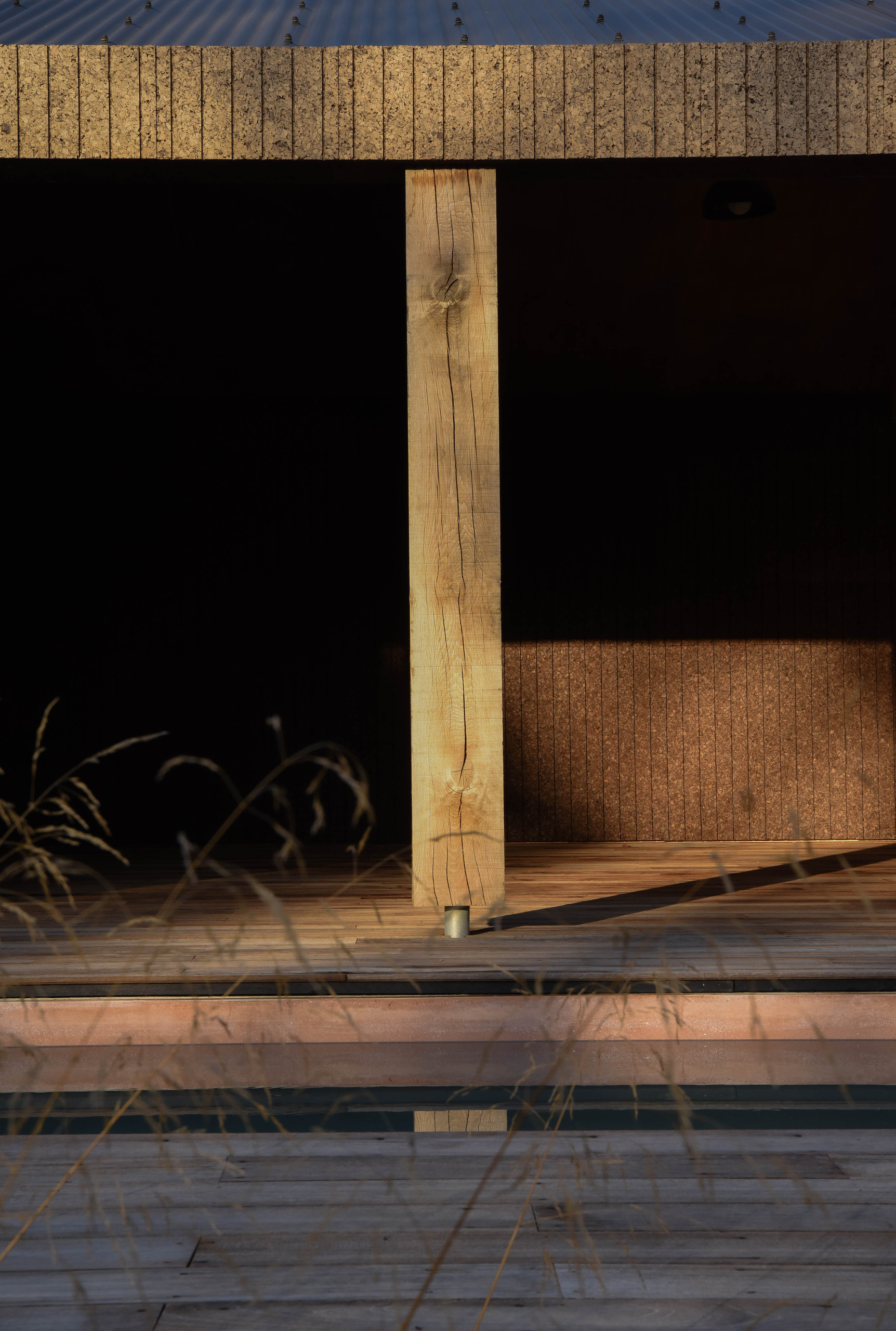 Covered deck with timber post and grasses
